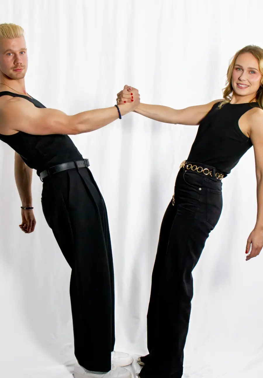 Matthew Link and Jordan Smith rehearsing, hands clasped mid-step